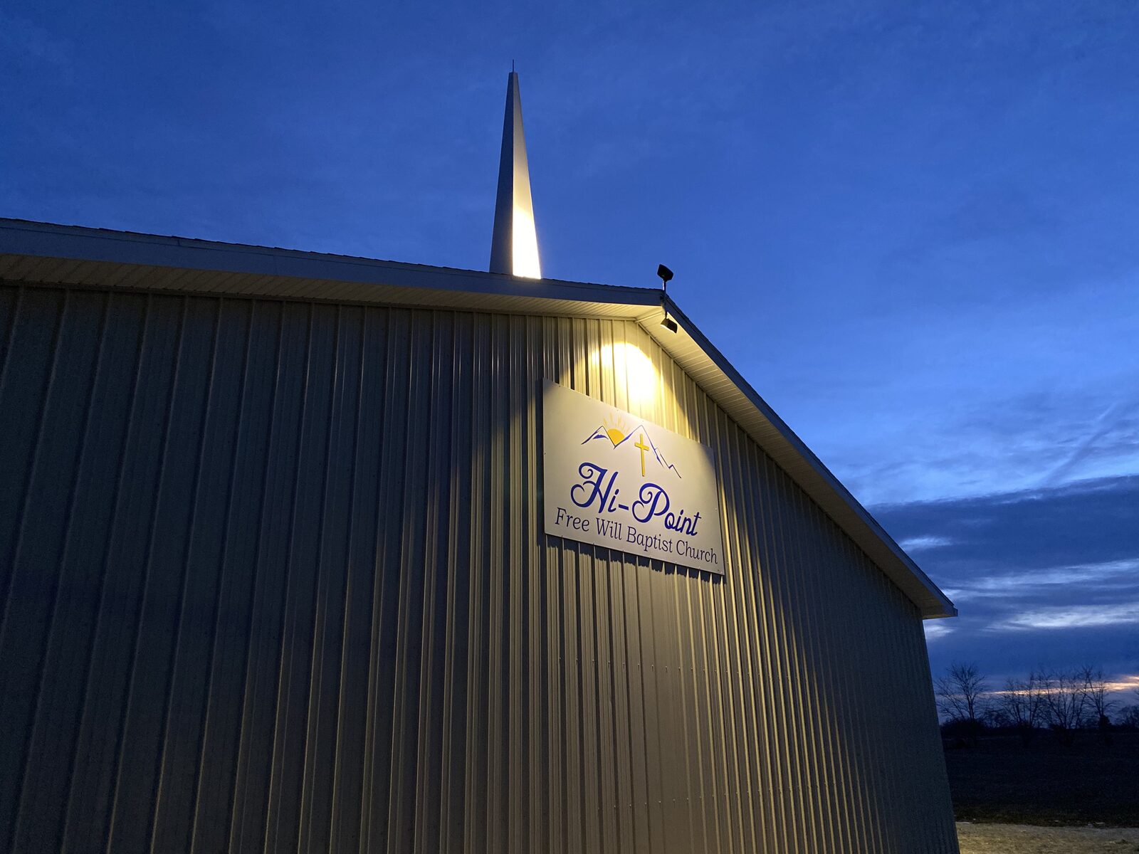 Hi-Point Free Will Baptist Church sign and steeple at dusk